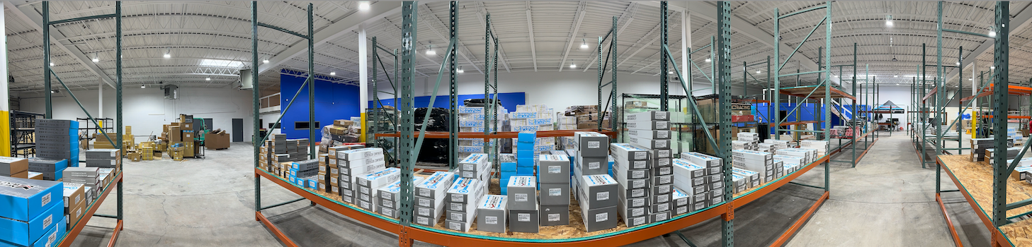 Wide view of coilover depot warehouse interior with shelves and storage areas.